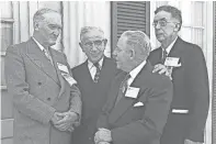  ?? FILES THE COMMERCIAL APPEAL ?? Rotarians making principal addresses at the Rotary Internatio­nal District 204 conference at The Peabody in April 1952 took time out for small talk before a luncheon meeting. Isaac B. Tigrett, second left, of Jackson, Tenn., president of Gulf, Mobile &...