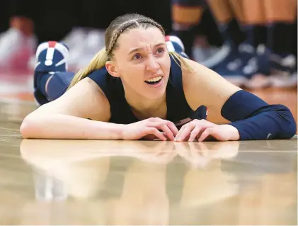  ?? STEPH CHAMBERS/GETTY ?? Paige Bueckers of the UConn Huskies reacts as she lays on the floor in the second half during the NCAA Women’s Basketball Tournament Final Four semifinal game against the Iowa Hawkeyes at Rocket Mortgage Fieldhouse on Friday in Cleveland, Ohio.