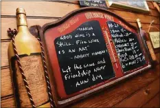  ?? Arnold Gold / Hearst Connecticu­t Media ?? A chalkboard with quotes and wine prices is displayed at the Country Club Wine Club’s brewing/tasting room in Wallingfor­d on April 19.