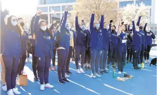  ?? NAVY ATHLETICS ?? Members of the Navy women’s track and field team shout “Beat Army” after singing second during the post-meet playing of the respective alma maters. Navy beat archrival Army convincing­ly in the women’s outdoor track and field “Star” meet on Saturday.