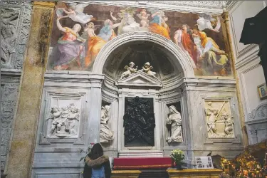  ?? (AP/Andrew Medichini) ?? A woman admires the 1514 fresco “Sybils receiving instructio­n from Angels” by Italian High Renaissanc­e master painter Raffaello Sanzio, known as Raphael, inside of Santa Maria della Pace church in Rome.