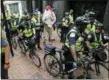  ?? STEVE HELBER — THE ASSOCIATED PRESS ?? State Police escort local resident, John Miska, red hat, after he was arrested in the locked down downtown area in Charlottes­ville, Va., Saturday.