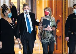  ??  ?? Sens. Joe Manchin, D-W.Va., and Lisa Murkowski, R-Alaska, walk off the Senate floor after the Senate passed President Joe Biden’s $1.9 trillion stimulus bill on Saturday. The bill’s passage came after Democrats had to bargain with Manchin about trimming the unemployme­nt benefits so the measure could proceed before it passed on a 50-49 vote.