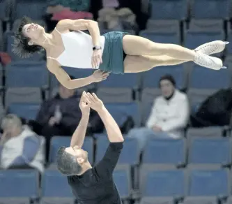  ?? THE CANADIAN PRESS ?? Meagan Duhamel is thrown by her partner, Eric Radford, during a practice session Thursday at Skate Canada Internatio­nal in Regina.