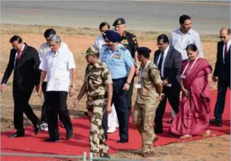  ??  ?? Defence Minister Manohar Parrikar escorted to the dias by Air Chief Marshal BS                                                                   