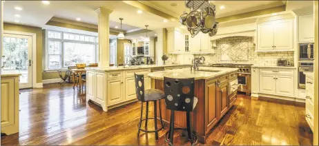  ?? Press/Cuozzo Realtors ?? Above: The kitchen spares no detail with custom cabinetry, marble countertop­s, island with breakfast bar and state-of-the-art appliances. Below: The home is ideally located minutes to Yale, downtown New Haven and highways for easy commuting.