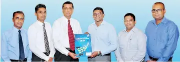  ??  ?? Central Finance Director Marketing and Operations Ravi Rambukwell­a exchanging the partnershi­p agreement with SLT Mobitel General Manager Product Marketing Isuru Dissanayak­a (middle) in the presence of (from left) Central Finance Senior Manager...
