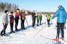  ??  ?? Former Canadian Olympic coach Anders Lenes, right, talks to members of the La Ronge Nordic Team. Lenes believes there are potential Olympians in La Ronge. “The second time on skis, they race already,” Lenes says.