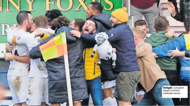  ?? ?? Delight Livingston players and fans celebrate winner