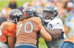  ?? Joe Amon, The Denver Post ?? Broncos defensive lineman Shelby Harris, right, takes on a double-team block during training camp Wednesday.