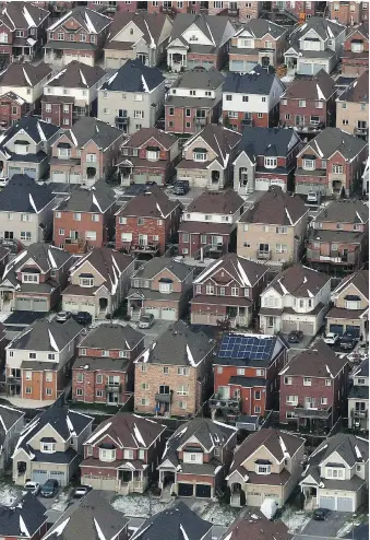  ?? LARS HAGBERG/THE CANADIAN PRESS FILES ?? The Canadian Real Estate Associatio­n says the mortgage stress test has lowered sales activity and destabiliz­ed market balance in regions where sales were already weak.