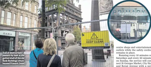  ??  ?? Trail of destructio­n: passers-by look at the gutted shell of the old Bank Buildings which housed Primark (inset)