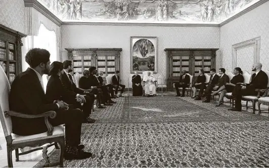  ?? Getty Images ?? Pope Francis, center, speaks with five NBA players Monday in his private studio at the Vatican. The pope spoke about the power of sports to create change, calling the players “champions” for their social justice efforts over the summer. Spurs guard Marco Belinelli was part of the delegation and spoke to the pope in Italian.