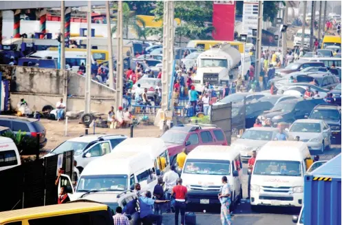  ?? Photo: Benedict Uwalaka ?? Motorists queue for petrol at Berger in Lagos yesterday