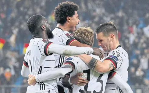  ?? ?? CRUCIAL STRIKE: Germany players celebrate after forward Thomas Mueller, second right, scored the team’s second goal against Romania in Hamburg.