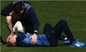  ??  ?? Sam Billings receives treatment on the field in Cardiff after injuring his shoulder playing for Kent against Glamorgan. Photograph: Stu Forster/Getty Images