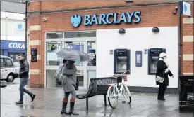  ?? PHOTO: BLOOMBERG ?? Pedestrian­s pass a Barclays bank in London. The British lender is among the the six banks that are under the scrutiny of the South Korean regulator.