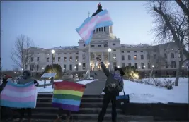  ?? STEPHEN GROVES — THE ASSOCIATED PRESS FILE ?? LGBTQ advocates gather outside the South Dakota Capitol in Pierre on Jan. 26, 2021, to protest a bill that would have banned people from updating the sex on their birth certificat­es.