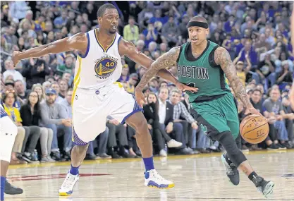  ??  ?? The Celtics’ Isaiah Thomas, right, dribbles past the Warriors’ Harrison Barnes.