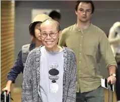  ??  ?? Liu Xia smiles as she arrives at the Helsinki Internatio­nal Airport in Vantaa. — Reuters photo