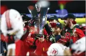  ?? CHASE STEVENS — THE ASSOCIATED PRESS, FILE ?? Utah players celebrate with the trophy after their victory over Oregon to win the Pac-12 Conference championsh­ip in December. The Pac-12 announced it was scrapping its divisional format for the coming season on Wednesday.