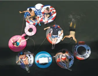  ?? Preston Gannaway / Special to The Chronicle ?? Inner tubes provide an Independen­ce Day excursion in the Russian River town of Forestvill­e. Because of the coronaviru­s pandemic, many favorite spots were closed for the holiday.