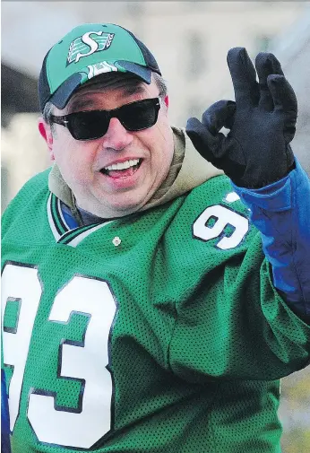  ?? NICK PROCAYLO ?? Corner Gas star Brent Butt waves to the crowd during the 102nd Grey Cup parade in Vancouver.