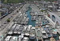  ?? ?? Fishing boats are docked for shelters in Yilan county as Typhoon Mawar approaches the east coast of Taiwan. — afp