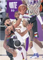  ?? AFP ?? The Nuggets’ Jamal Murray, left, drives to the basket against the Lakers’ Kentavious Caldwell-Pope, No.1, during the third quarter.