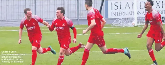  ??  ?? United’s Scott Donnelly, second from left, celebrates his goal against Hartley Wintney on Saturday