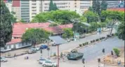  ?? AFP ?? An armoured personnel carrier stands at an intersecti­on in Harare on Wednesday, with Zimbabwe’s soldiers regulating traffic.