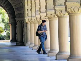  ?? David Paul Morris / Bloomberg 2011 ?? A student heads to class at Stanford University, where a survey has found that the school’s graduates have started several successful companies.