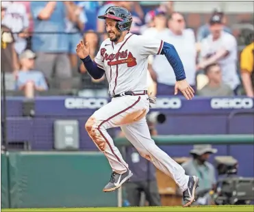  ?? Dale Zanine ?? Atlanta Braves catcher Travis d’Arnaud scores a run against the San Diego Padres during the eighth inning at Truist Park.