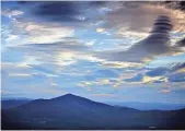  ?? ROBERT F. BUKATY, AP ?? Clouds over Mount Kearsarge North in Intervale, N.H., take on elongated shapes as strong winds blow cooler and drier air into the region on Thursday.