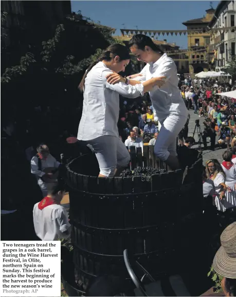  ??  ?? Two teenagers tread the grapes in a oak barrel, during the Wine Harvest Festival, in Olite, northern Spain on Sunday. This festival marks the beginning of the harvest to produce the new season’s wine Photograph: AP