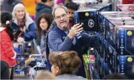 ??  ?? A Walmart associate helps customers shop Black Friday deals at the retailer’s store event, on Thursday 28 November 2019, in Bentonvill­e, Arkansas. Photograph: Gunnar Rathbun/AP