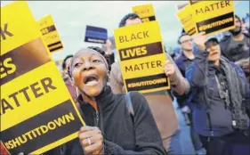  ?? Cindy Schultz / times union archive ?? regina Burns of Albany chants “Black Lives matter” during an April 3, 2015, rally outside the Albany police south station. Citizens gathered to protest the death of donald “dontay” ivy, who died after he was shocked with a stun gun.