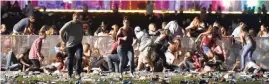  ?? AFP/ David Becker/Getty Images ?? HORRIFIC! Nagtatakbu­han ang mga tao mula sa Route 91 Harvest country music festival matapos marinig ang mga putok ng baril nitong Oktubre 1, 2017 sa Las Vegas, Nevada.