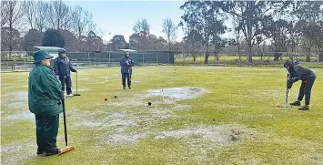  ?? ?? Puddles of water greeted Warragul and Drouin Gold players when golf croquet pennant competitio­n returned last week.