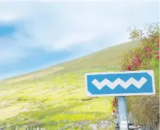  ?? GETTY IMAGES ?? Some believe that the white-on-blue-waves road signs on Ireland’s Wild Atlantic Way were a marketing scheme to get tourists off the beaten track.