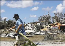  ?? DAVID GOLDMAN — THE ASSOCIATED PRESS ?? Rob Brehm cleans up debris from his home across the street from a house that Hurricane Irma demolished in Goodland, Florida, on Tuesday.