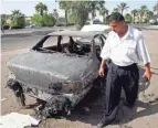  ?? KHALID MOHAMMED/AP, FILE ?? An Iraqi policeman inspects a car destroyed by a security detail in al-nisoor Square in Baghdad on Sept. 25, 2007.