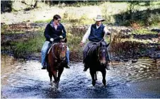  ?? Photo: Bev Lacey ?? Tara Miko on Harmony and Gordon Country horseman John Ryrie on Mona Lilsa enjoy some old-fashioned transporta­tion.