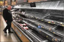  ?? MATT ROURKE / ASSOCIATED PRESS ?? Initial demand for water and paper products has shifted over to food. Suppliers and big chains like Walmart are working hard to ramp up production, while assuring that shortages are only temporary in these unpreceden­ted times.