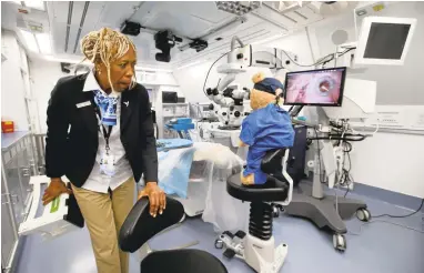  ?? KARLMONDON/STAFF PHOTOS ?? Head nurse Angela Purcell straighten­s up an operating room aboard the Orbis Flying Eye Hospital, constructe­d inside a converted jumbo jet formerly owned and operated by FedEx, during a visit Thursday at Moffett Federal Airfield in Mountain View.