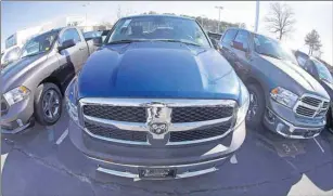  ?? CP PHOTO ?? Ram pickup trucks are on display on the lot at Landmark Dodge Chrysler Jeep RAM in Morrow, Ga., Tuesday. Fiat Chrysler Canada, one of the biggest car manufactur­ers in the country, says it saw its annual sales rise 1.1 per cent in 2015 in what is...