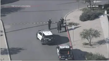  ?? TELEVISION, KNXV ?? THIS IMAGE MADE FROM VIDEO PROVIDED BY KNXV shows law enforcemen­t outside an Amazon delivery hub in the Phoenix suburb of Chandler on Wednesday. Police say that a person with a gun shot and wounded a contract worker outside the Amazon delivery station in Arizona before another contract worker who was armed fatally shot the suspect in the parking lot Wednesday, possibly stopping an active shooter situation.