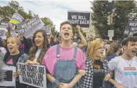  ?? Tasos Katopodis, Getty Images ?? Protesters block the street in front of the U.S. Supreme Court in Washington as justices hear arguments about gender identity and workplace discrimina­tion Tuesday.
