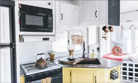  ?? Mandy Holesh ?? Mandy and Kevin Holesh cook most of their meals in the kitchen that they renovated in their 188-square-foot camper.