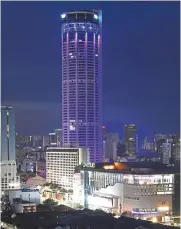  ?? — ZHAFARAN NASIB and G.C. TAN/The Star ?? Coloured towers: Komtar (left) lit up in purple hues in George Town as Menara Alor Setar gets a dash of colour in conjunctio­n with World Cancer Day 2021.